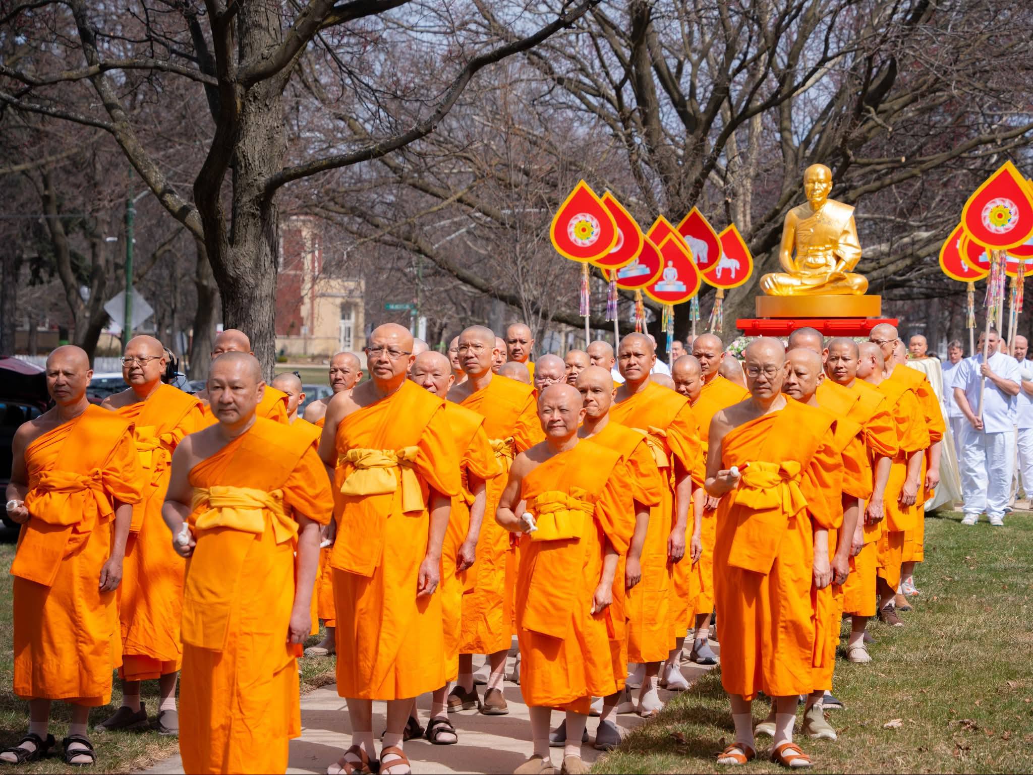 Monks in procession honoring the legacy of Phramongkolthepmuni